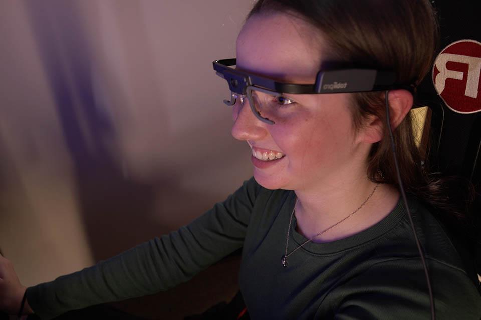 Teen wearing eye-tracking glasses worn by participants during driving simulation training and assessments.